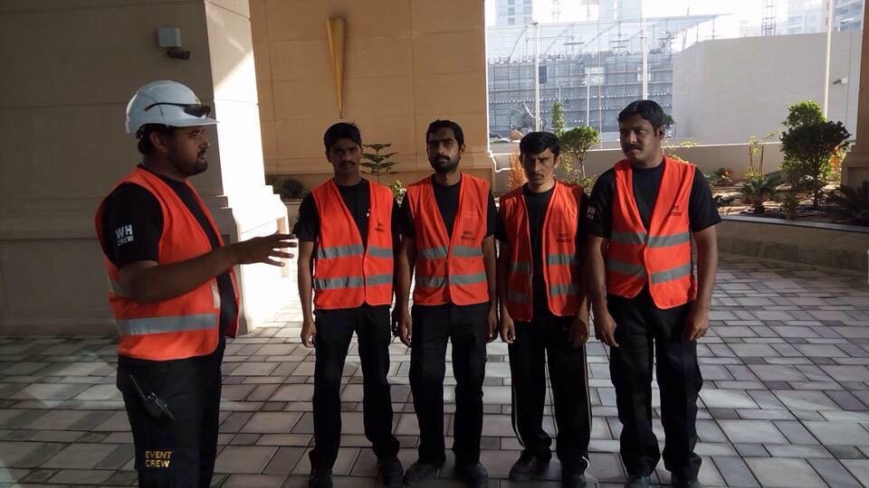 Professional event crew team setting up stage equipment in Saudi Arabia for a corporate event